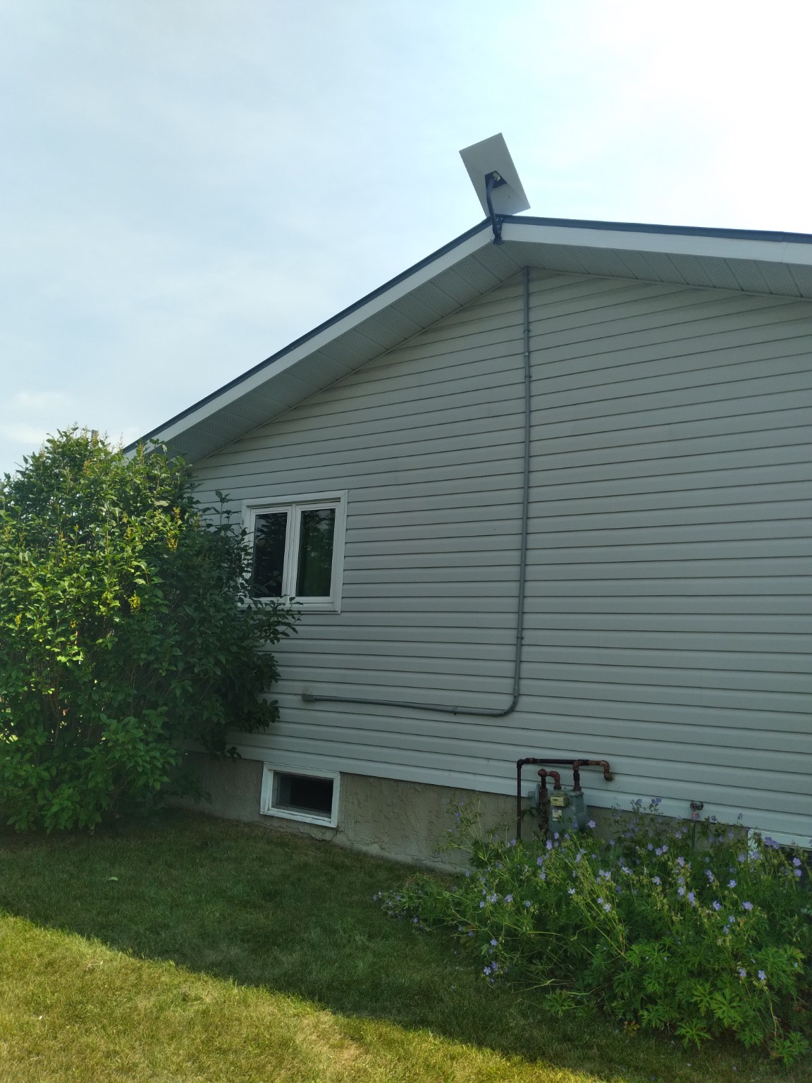 Starlink installation with protected conduit on a residential gable